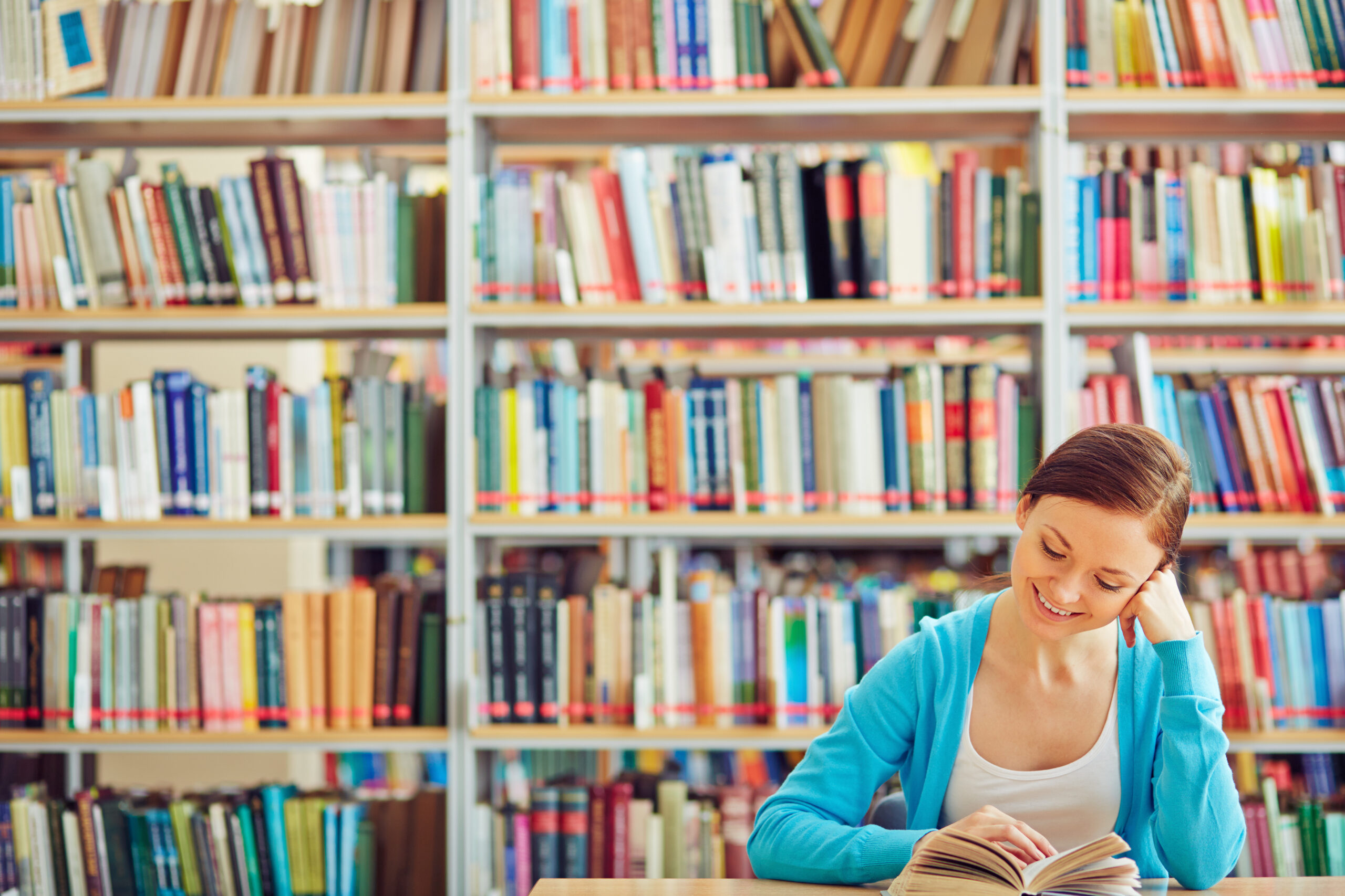 Curious student reading interesting book in library
